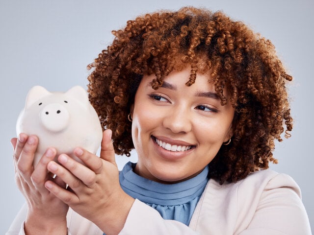 WRI Women Smiling About Saving with Piggy Bank (1)-1